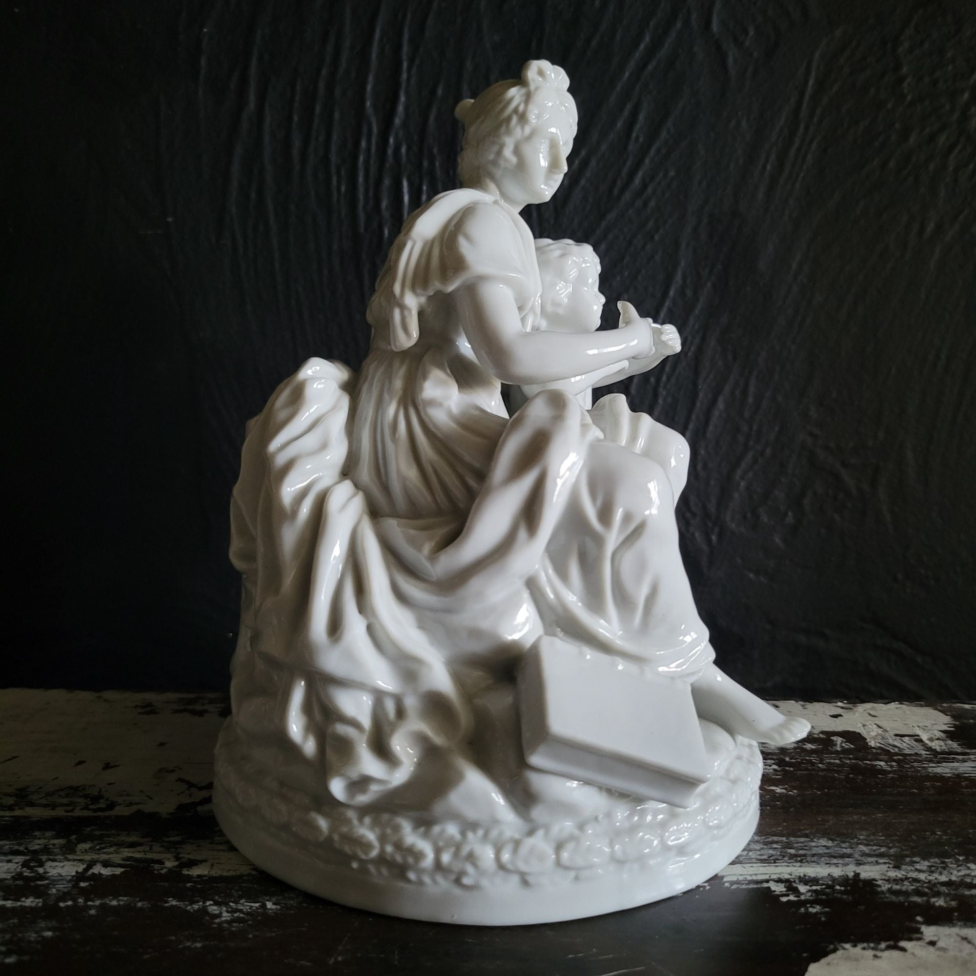 Vintage White Porcelain Figurine Of Woman and Child with Book On Floral Base