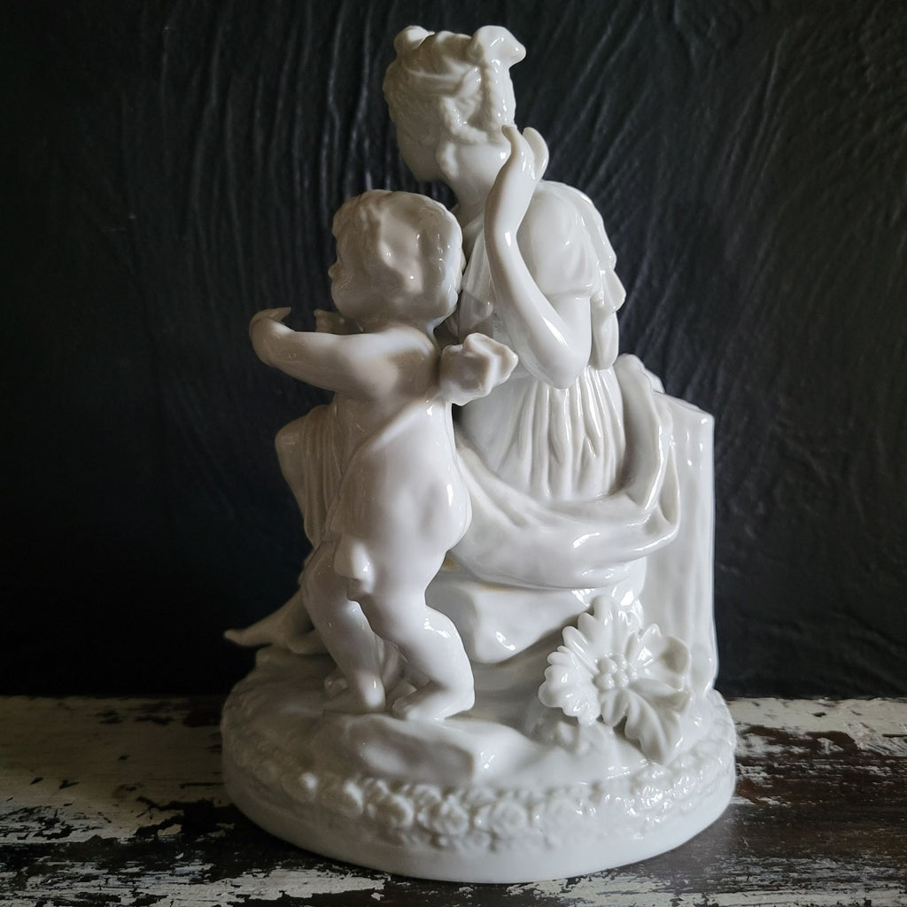 Vintage White Porcelain Figurine Of Woman and Child with Book On Floral Base