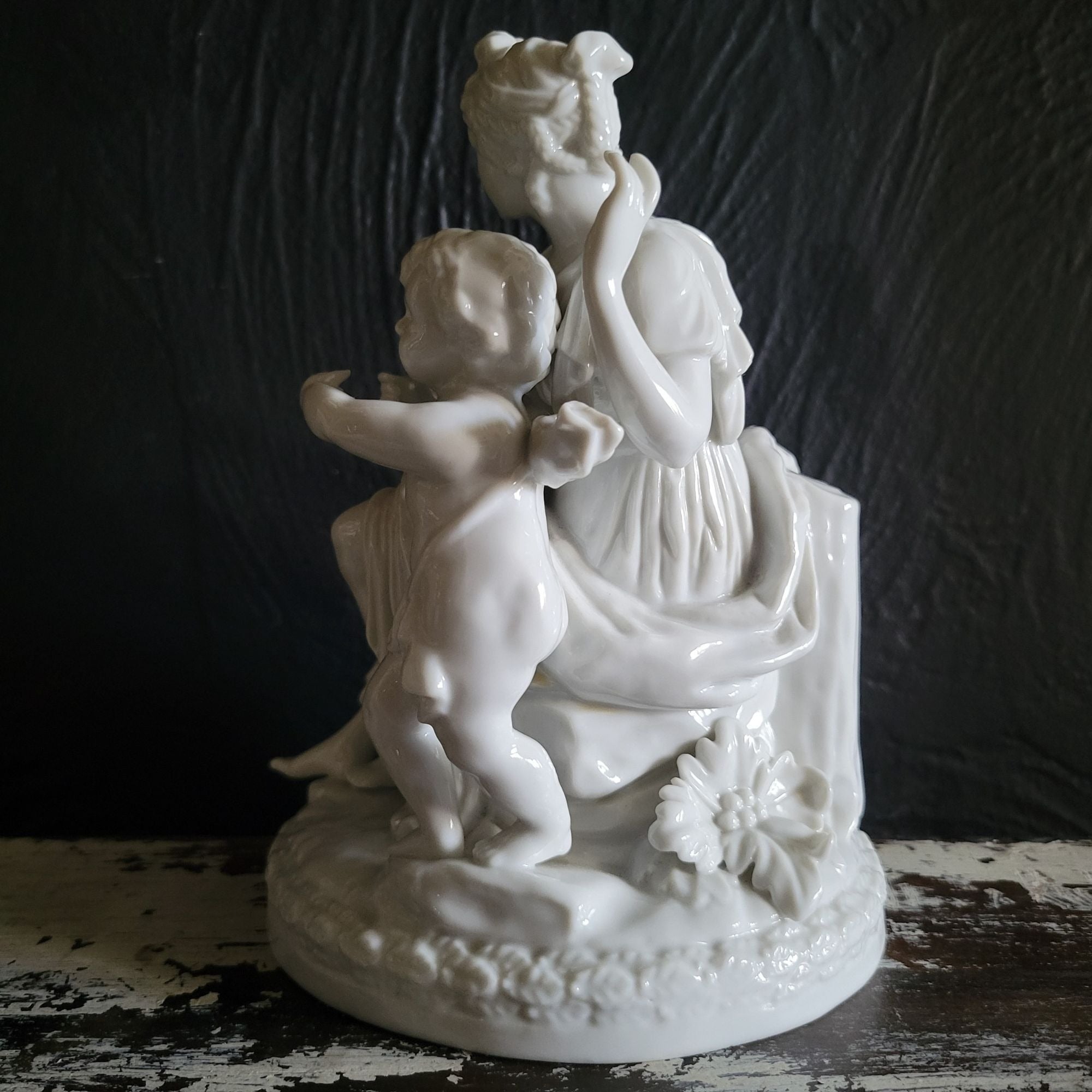 Vintage White Porcelain Figurine Of Woman and Child with Book On Floral Base